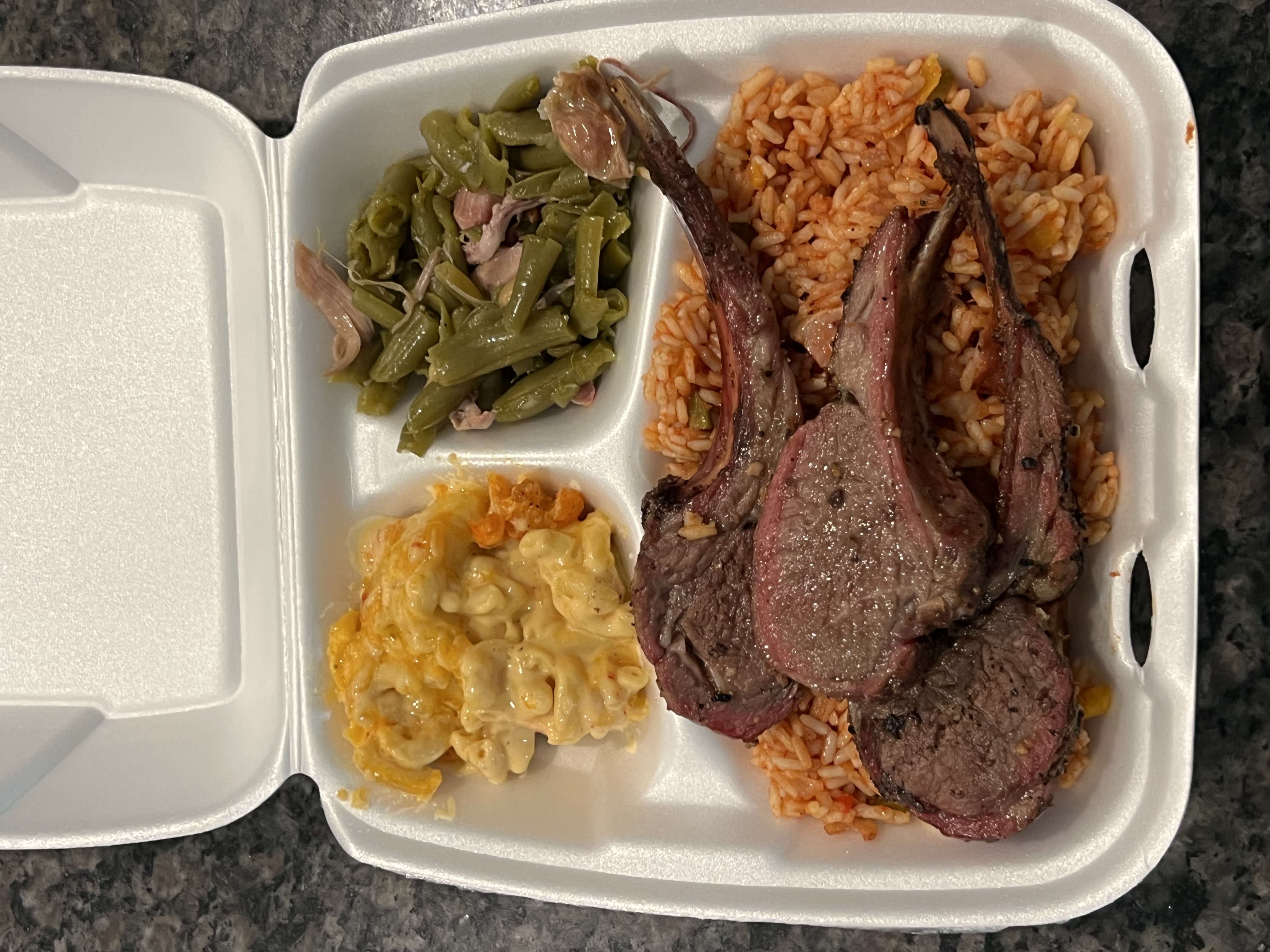 Smoked brisket slices with sides in a to-go container