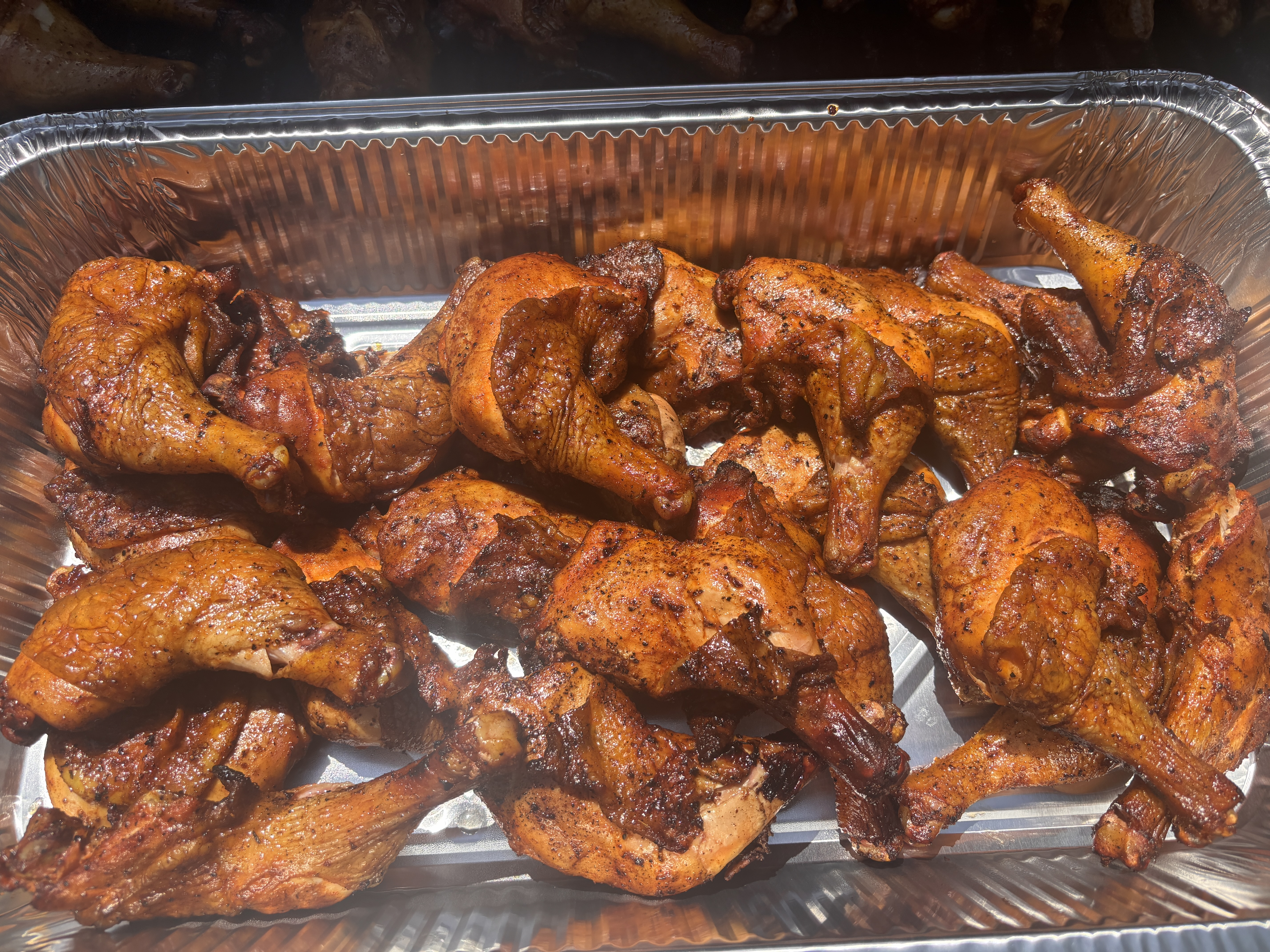 BBQ chicken quarters plated in a serving tray