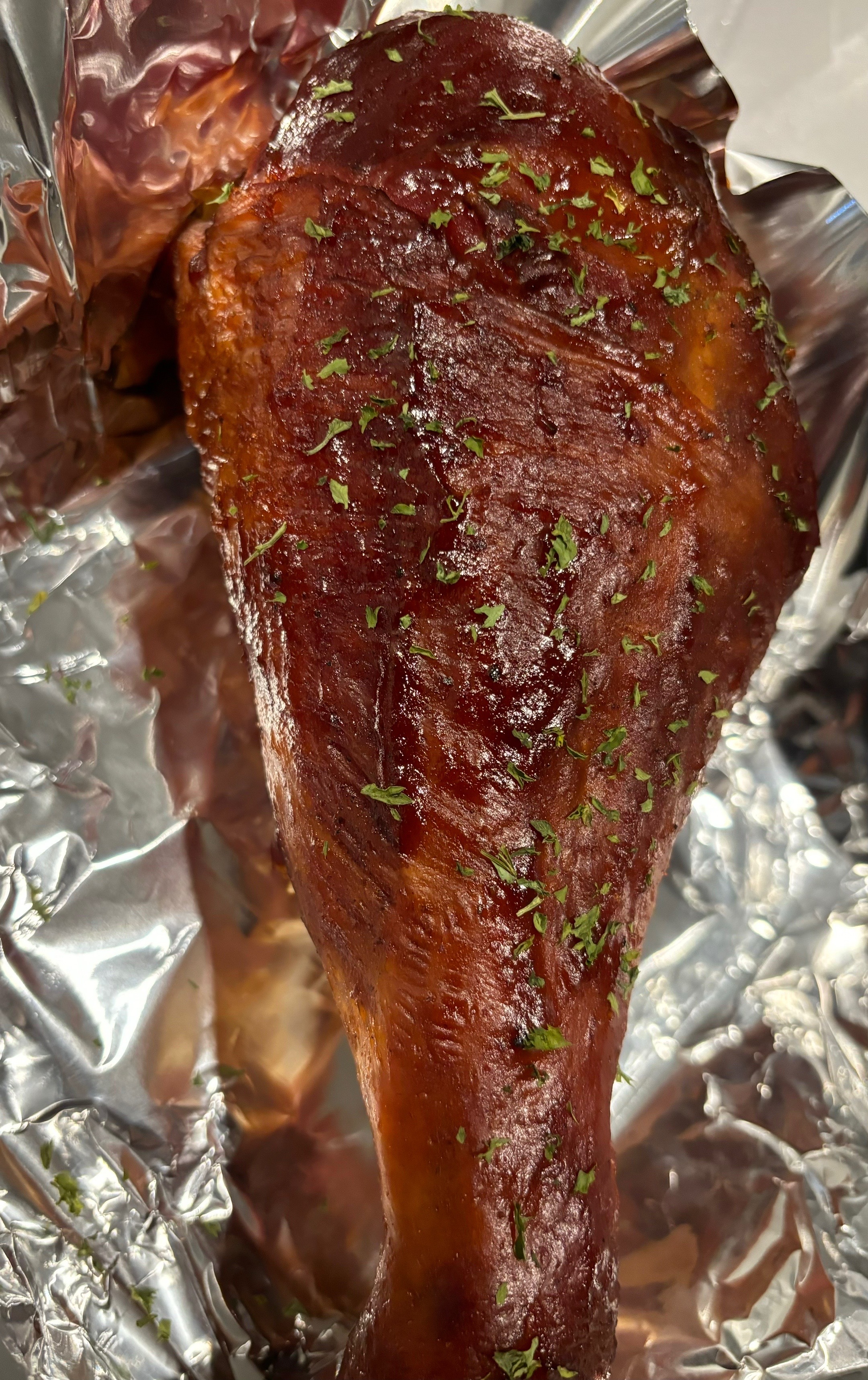 Giant smoked turkey leg wrapped in foil