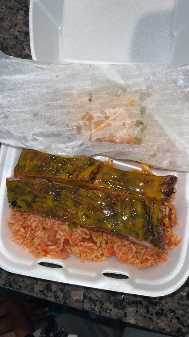 Cabbage over red rice in a to-go container
