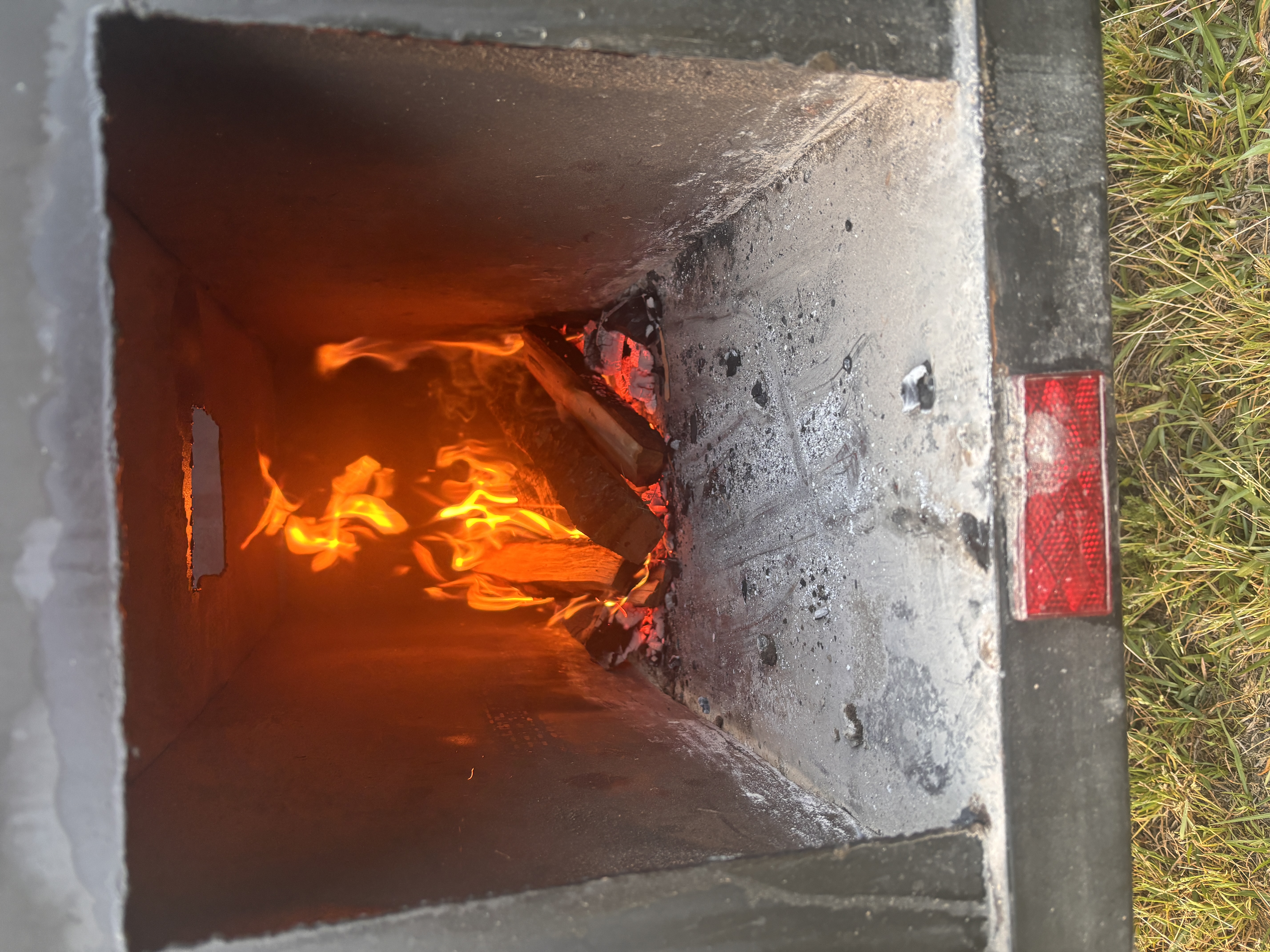 Live fire burning inside a mobile smoker